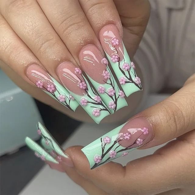 Elegant Cherry Blossom Nail Design on Mint Green Background: A Sophisticated Spring Aesthetic.