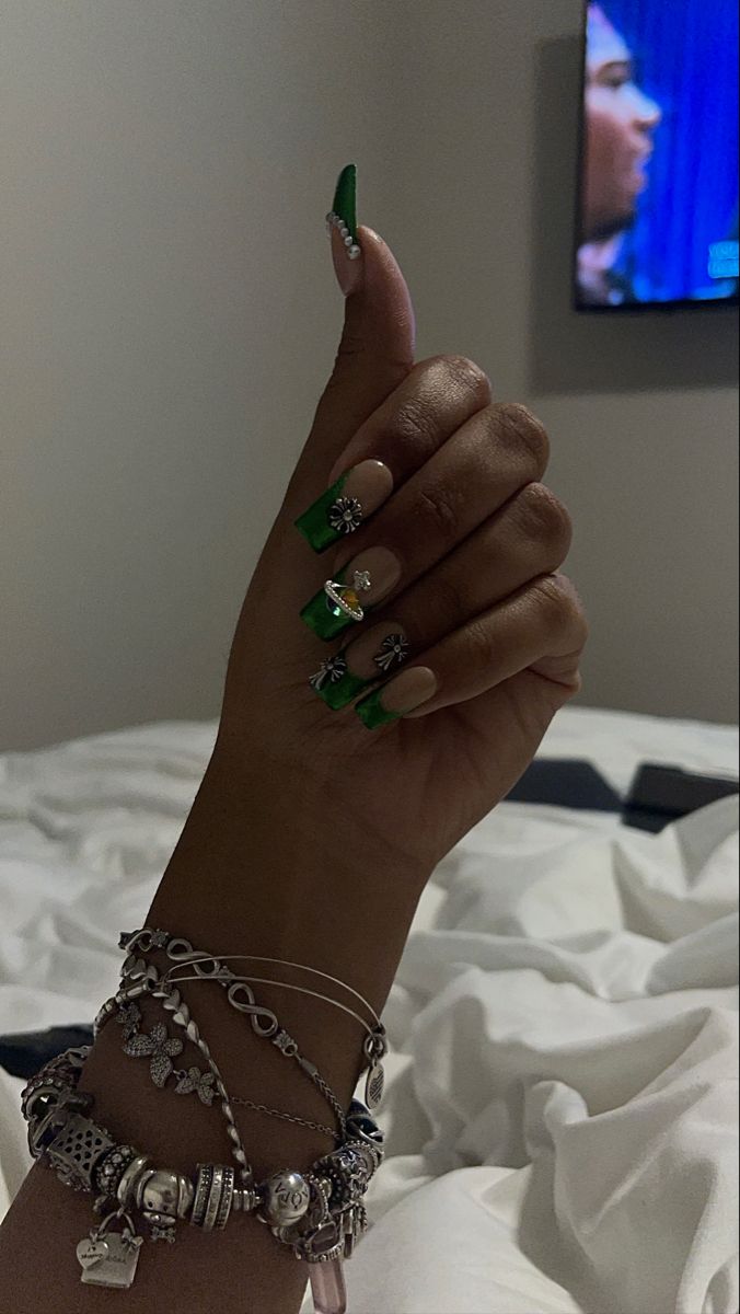 Chic and Bold: Vibrant Green Nail Design Enhanced by Charms and Bracelets