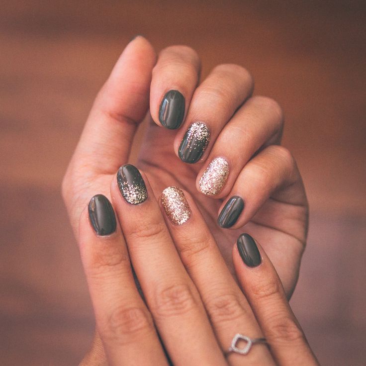 Elegant Nail Design: Dark Colors Enhanced with Glitter for Glamour.