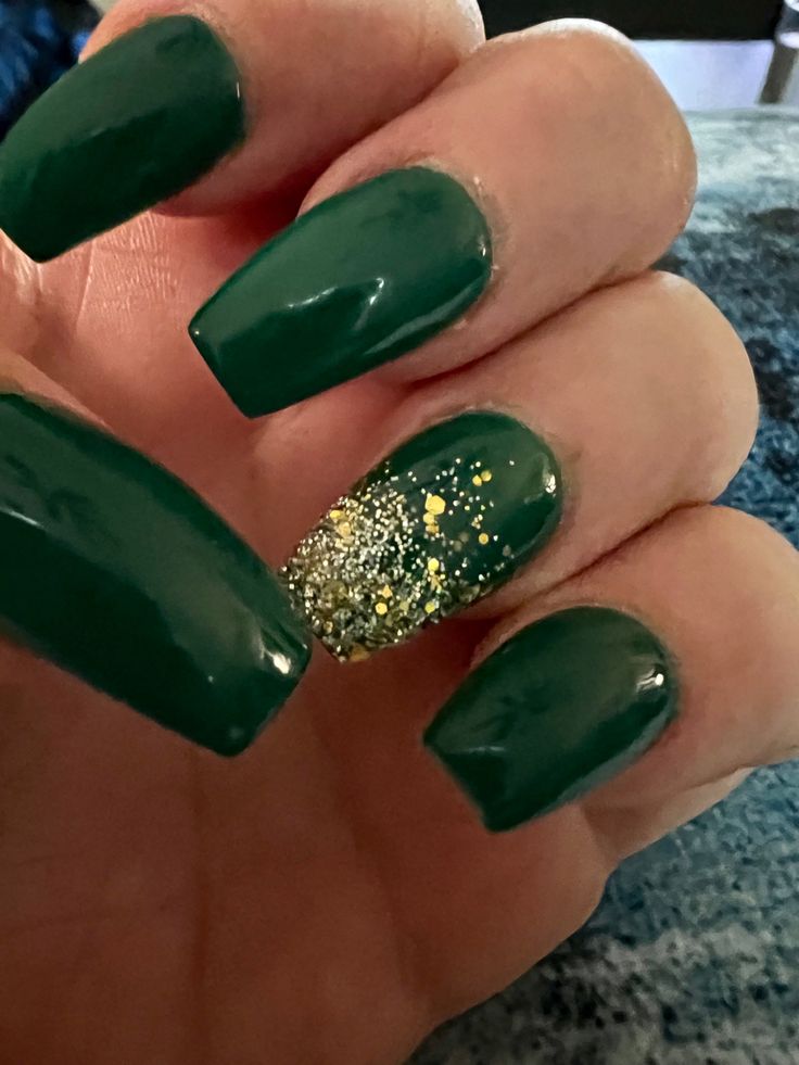 Elegant Glossy Green Nail Design with Pointed Tips and Glitter Gradient Accent.