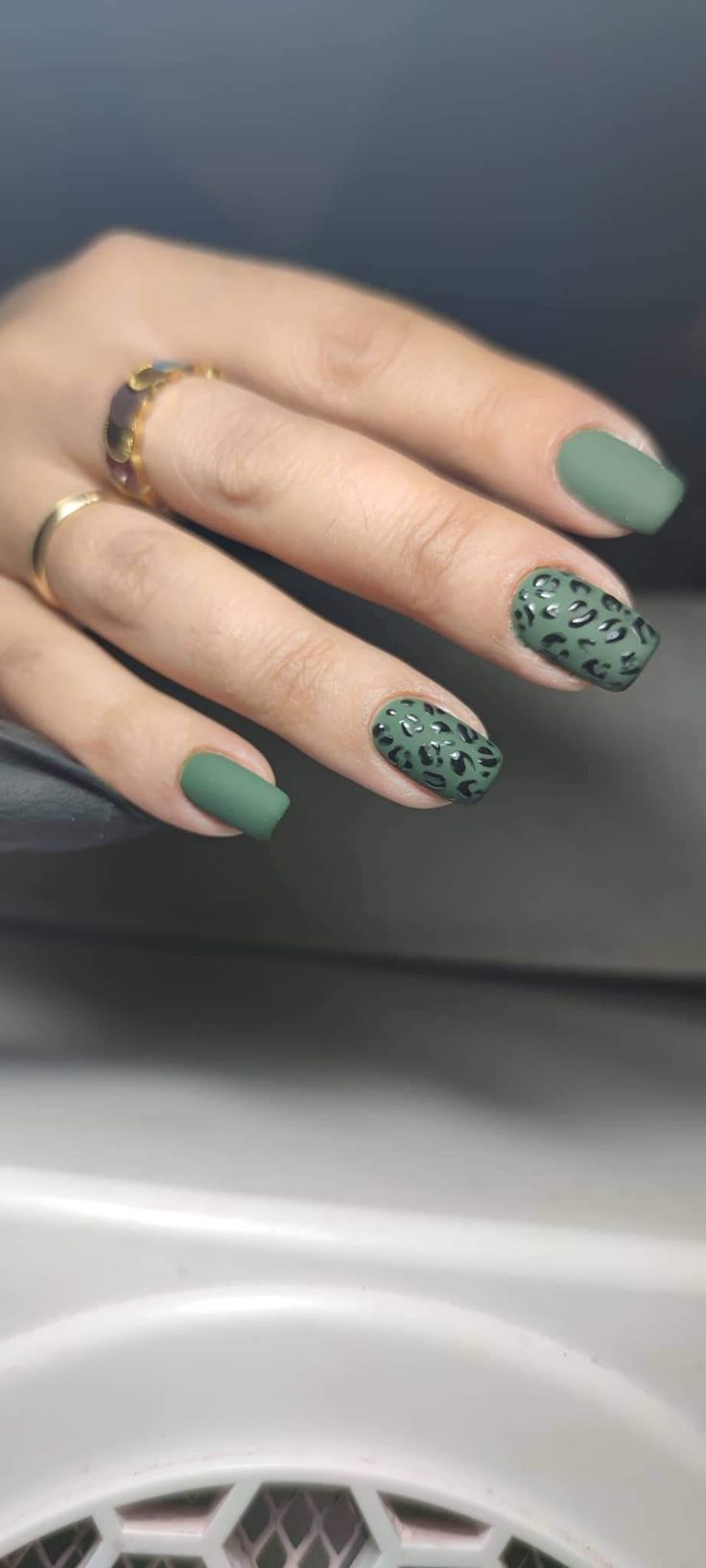 Bold Matte Green Nail Design with Leopard Accent for a Sophisticated Statement Look.