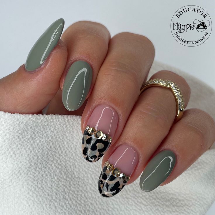 Chic Nail Design: Muted Green and Neutral Shades with Leopard Print and Rhinestones.