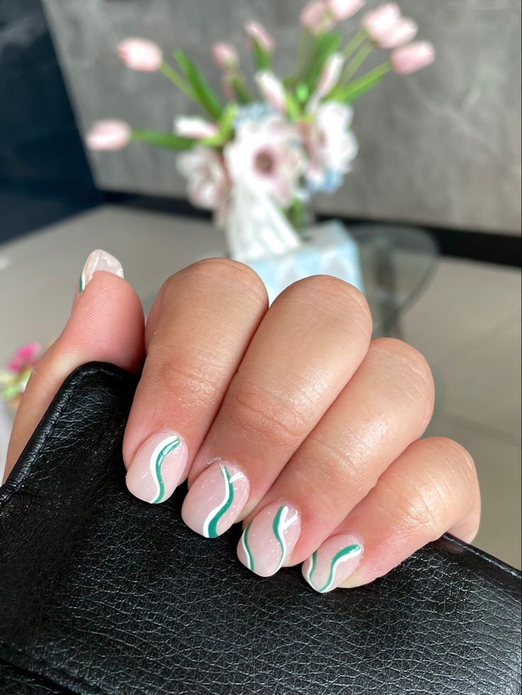 Elegant Nail Design with Clear Base and Delicate White & Teal Waves for a Trendy Look.