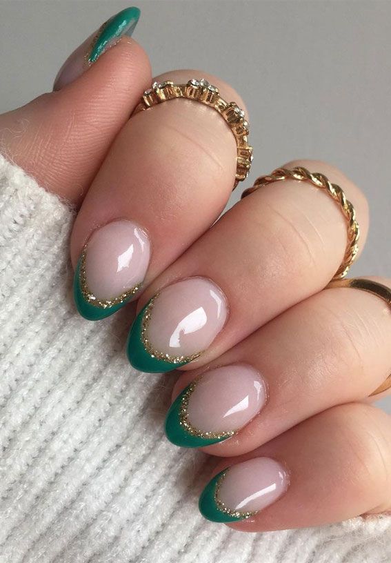 Chic Nail Design: Sophisticated Nude Base with Vibrant Teal Tips and Gold Accents.