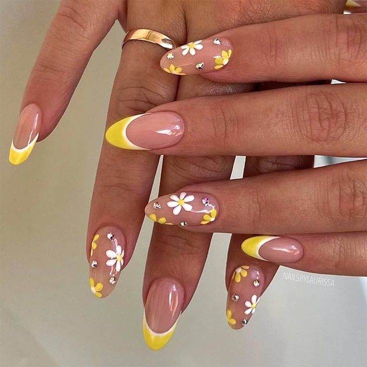 Delicate Floral Nail Design with Yellow French Tips and Rhinestones for a Cheerful Touch.