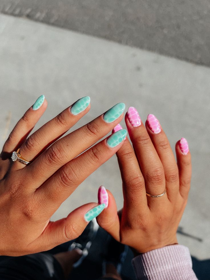 Playful Mint Green and Soft Pink Nail Design with Unique Textures and Contrasting Patterns for a Trendy Statement.