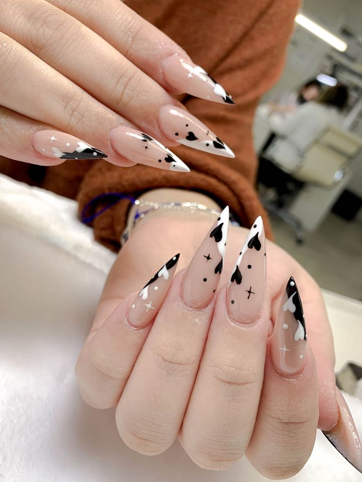 Chic Long Nails: Sophisticated Nude and Glossy Black Design with Heart Shapes and Sparkly Accents