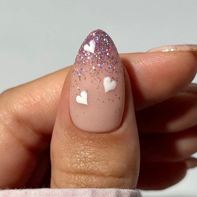 Chic Ombre Nail Design with Nude and Shimmering Purple Glitter Accents