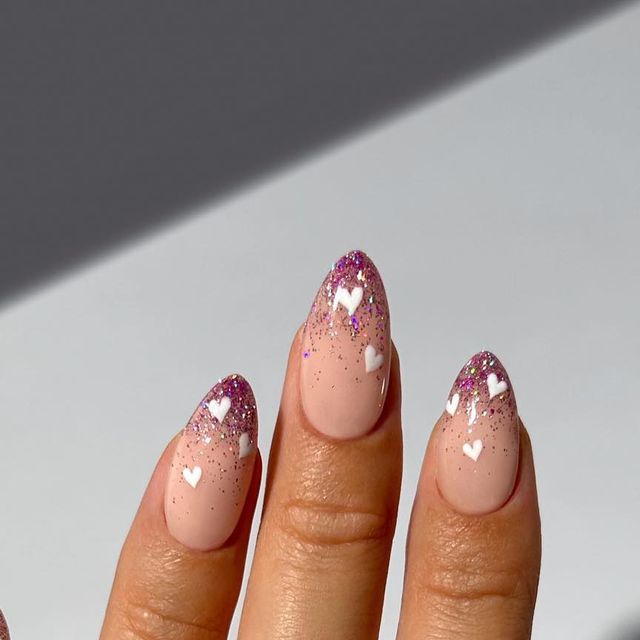 Elegant Nude Gradient Nails with Purple Glitter Tips and White Heart Accents