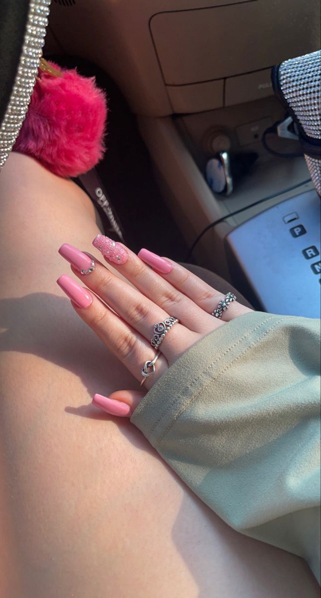 Chic Pastel Pink Nails with Sparkly Accent: A Sophisticated and Playful Design.