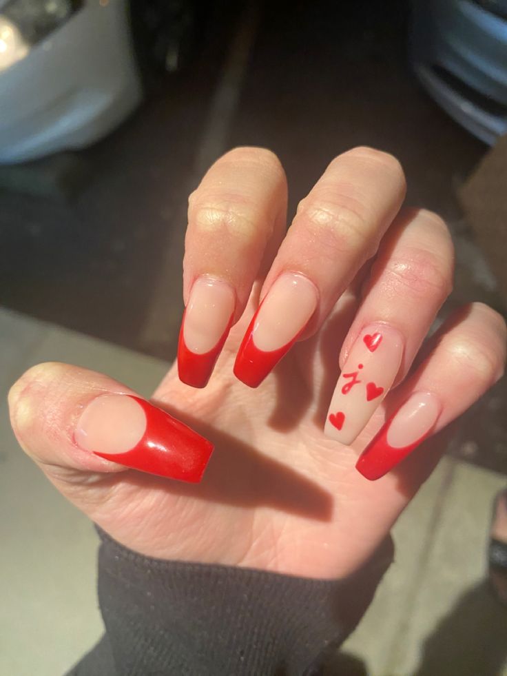 Bold Red French Tips with Whimsical Heart Motifs for Stylish Elongated Nails.