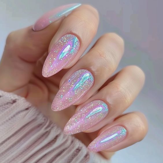 Elegant Iridescent Nail Design: Soft Pink Base with Shimmering Glitter on Almond-Shaped Nails.