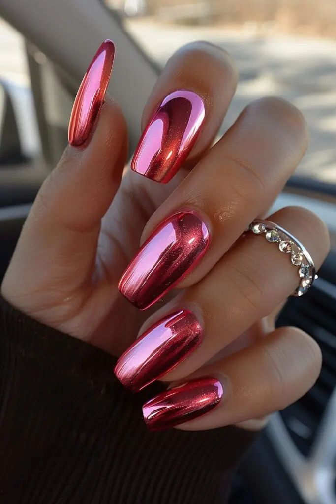 Glamorous Metallic Pink Nails: Vibrant Glossy Finish with Elegant Elongated Shape.