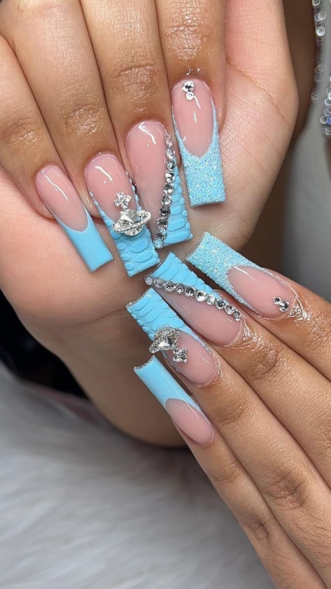 Chic Nail Art: A Glamorous Fusion of Soft Pink and Baby Blue with Textures and Sparkle.