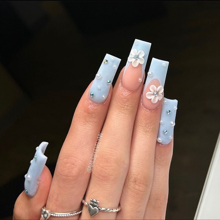 Charming Soft Blue Matte Long Nails with 3D Flowers and Rhinestones for a Refreshing Stylish Look.