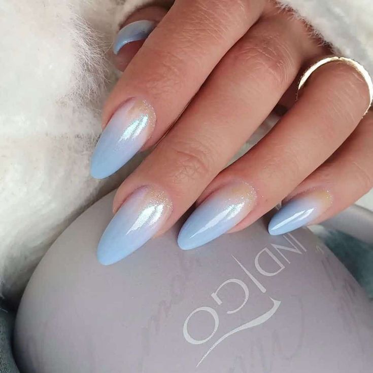 Chic Pastel Blue Almond-Shaped Nails with Shimmering Cuticle Detail.