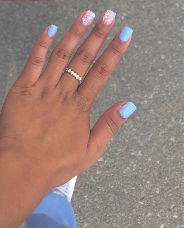 Chic Light Blue Manicure with Creative Pink Accents and Modern Square Shapes.