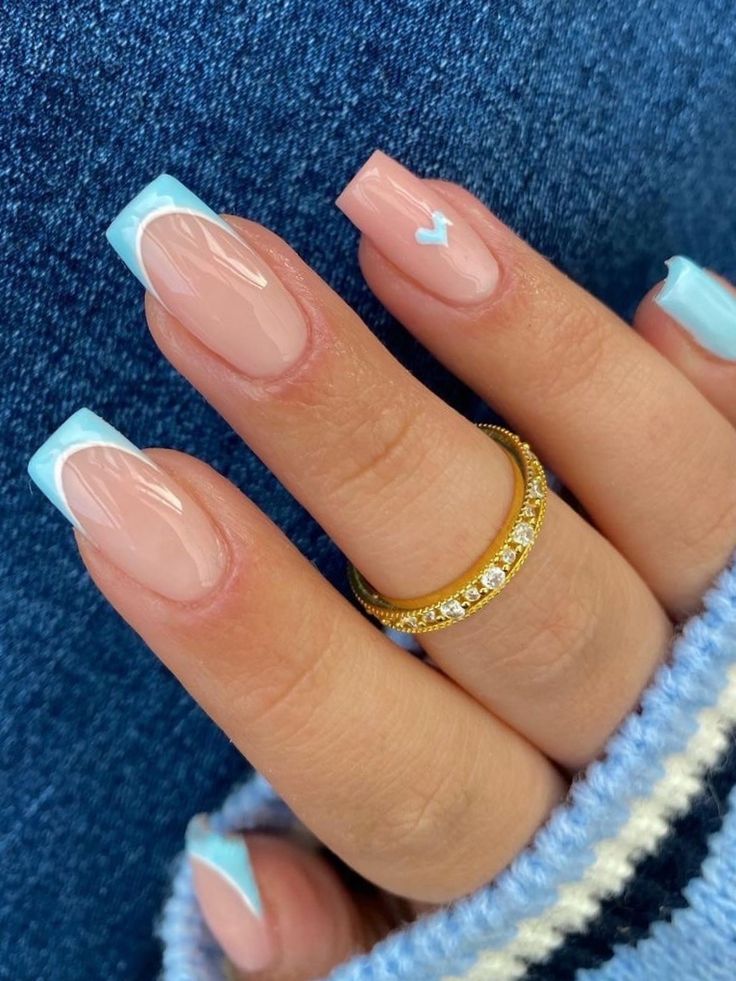 Chic Pastel Nail Design with Whimsical Heart Detail and Light Blue Tips