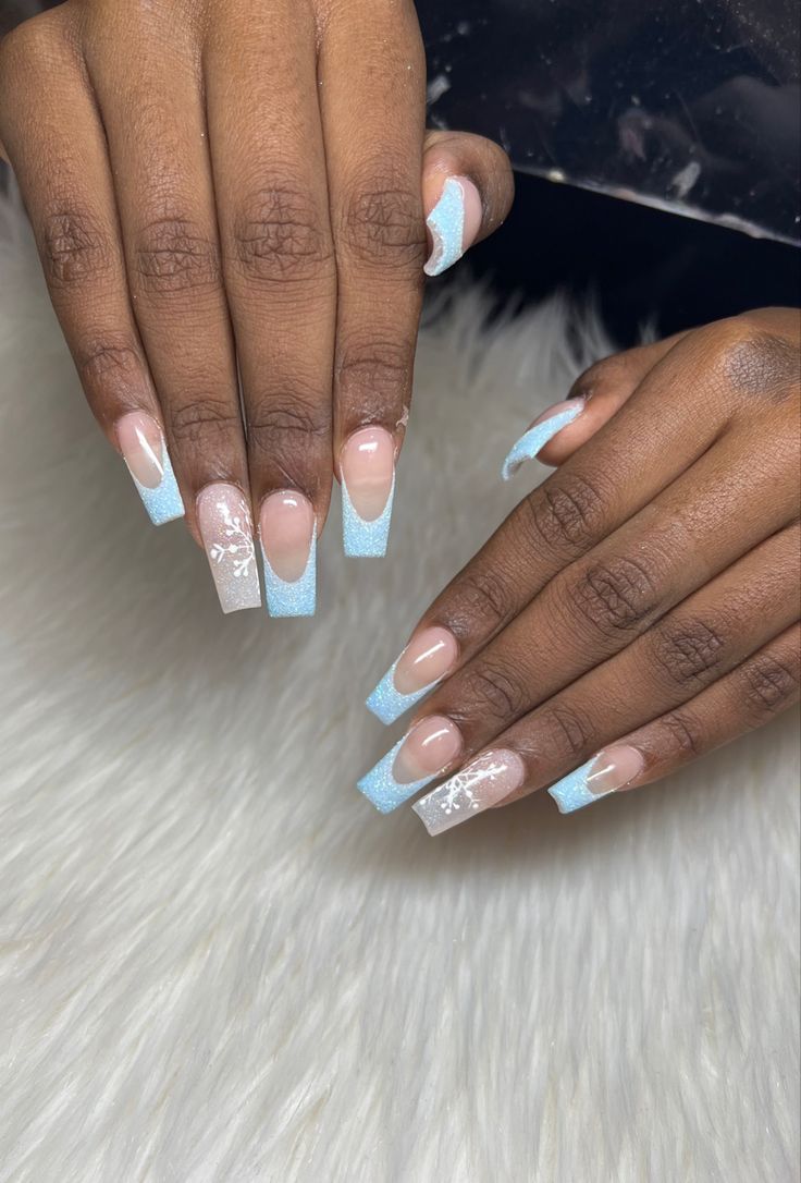 Elegant Gradient Nail Design with Nude and Icy Blue Shades and Floral Accents