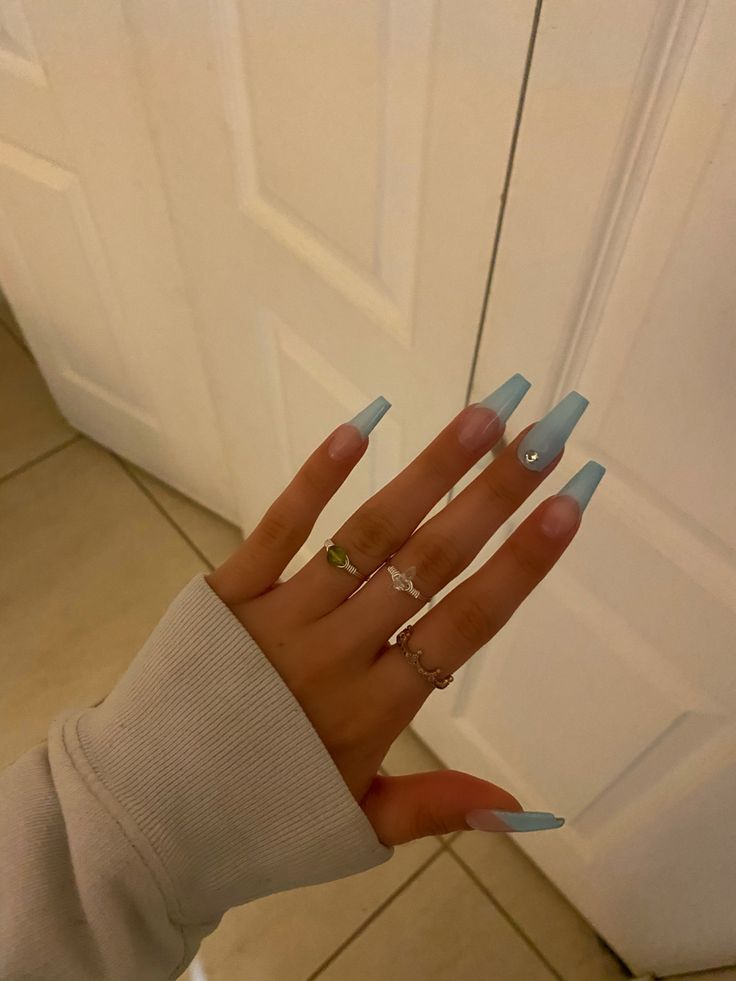 Chic Pastel Blue Long Nails with Elegant Pearl Accent and Contrasting Rings