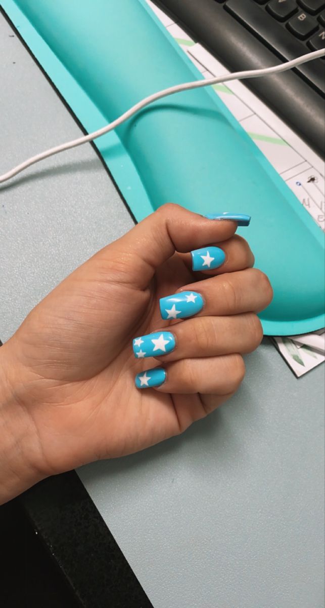 Vibrant Turquoise Nail Design with Playful White Star Accents