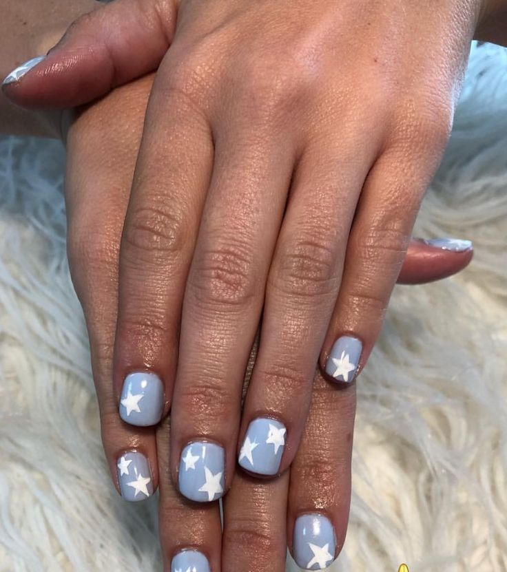 Whimsical Soft Blue Nail Design with White Stars for a Cheerful Spring/Summer Look.