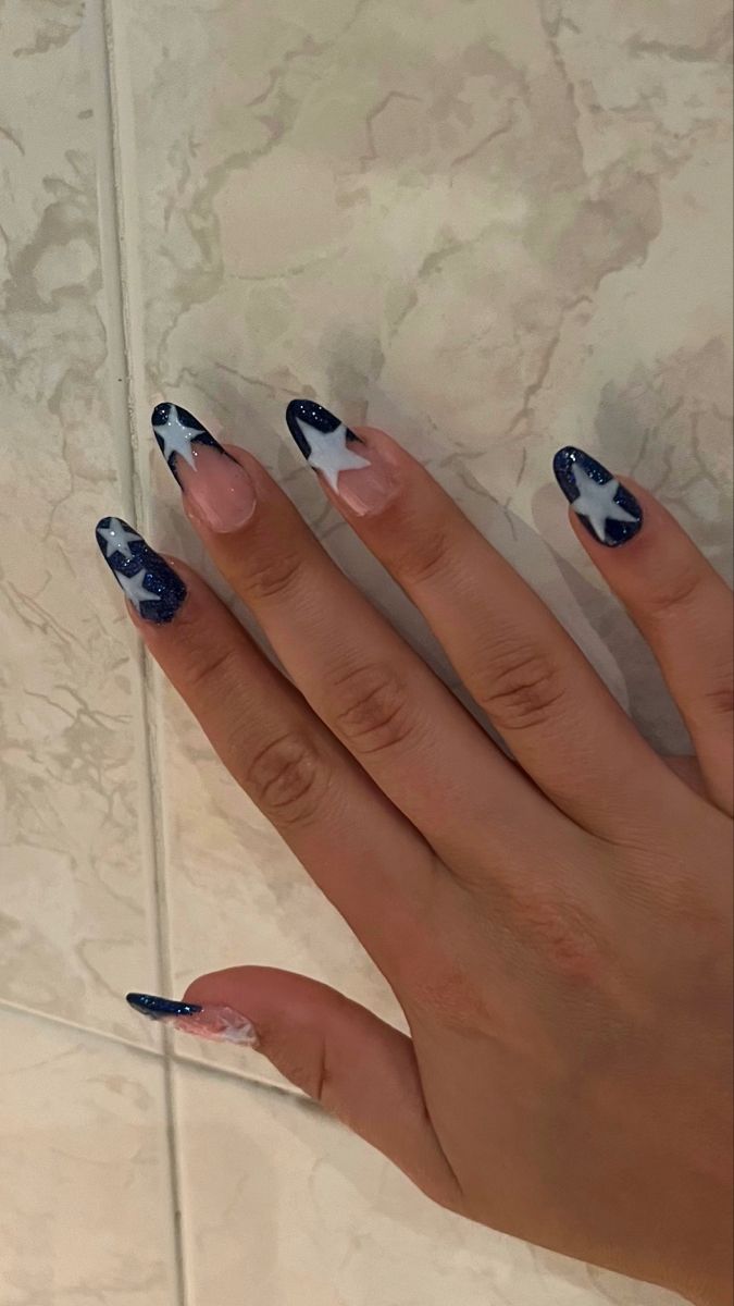 Elegant Navy Blue and Pastel Nail Design with Sparkling Star Patterns.