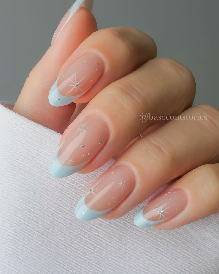 Whimsical Baby Blue Tip Nail Design with Sheer Base and Sparkling Accents.