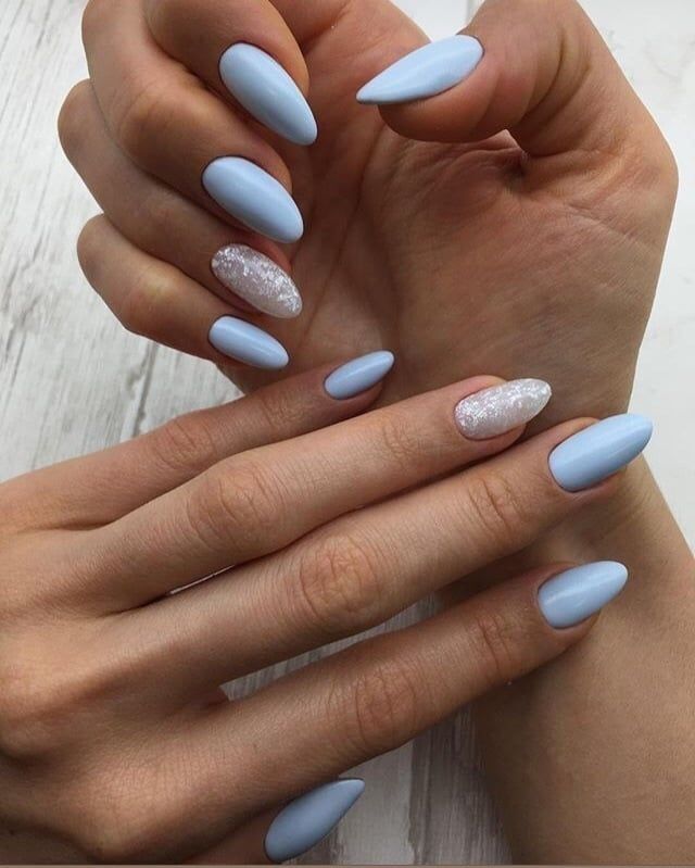 Pastel Blue Matte Almond Nails with Silver Glitter Accents: A Trendy Blend of Elegance and Glamour.