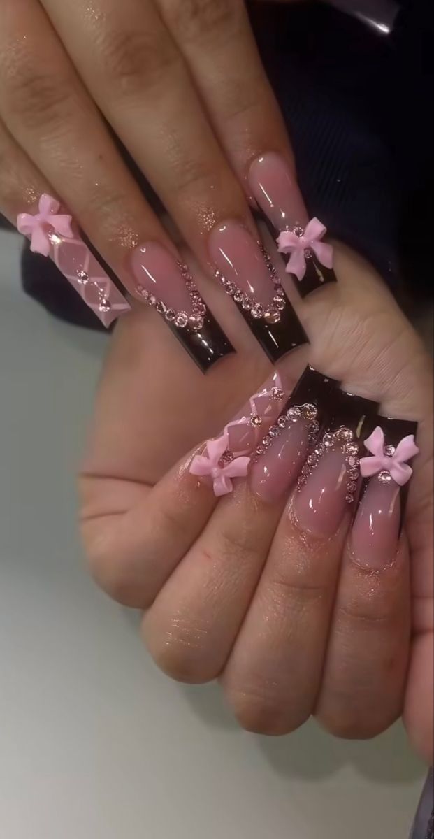 Chic Nail Design: Soft Pink and Glossy Black with Bows and Rhinestones