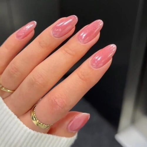 Elegant Soft Pink Almond-Shaped Nails with Shimmer and Gradient Effect for a Chic Look.