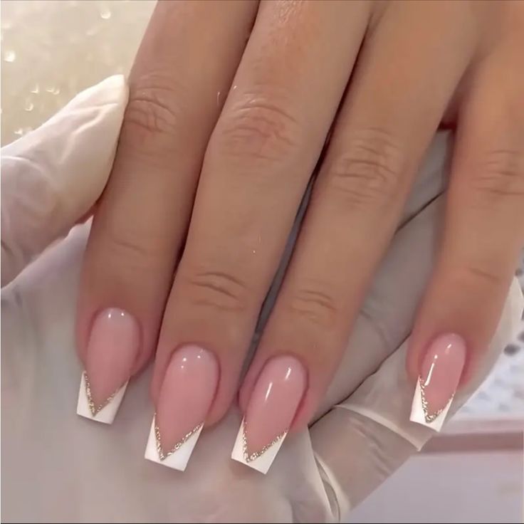 Chic Pink French Manicure with Gold Accents: A Modern Take on Elegance.