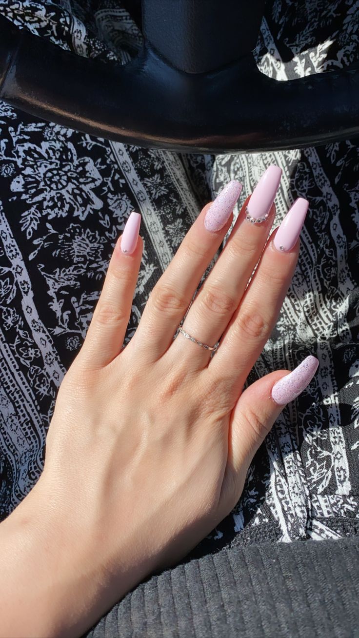 Chic Soft Pink Long Nails with Textured Accents for Elegant Glamour.