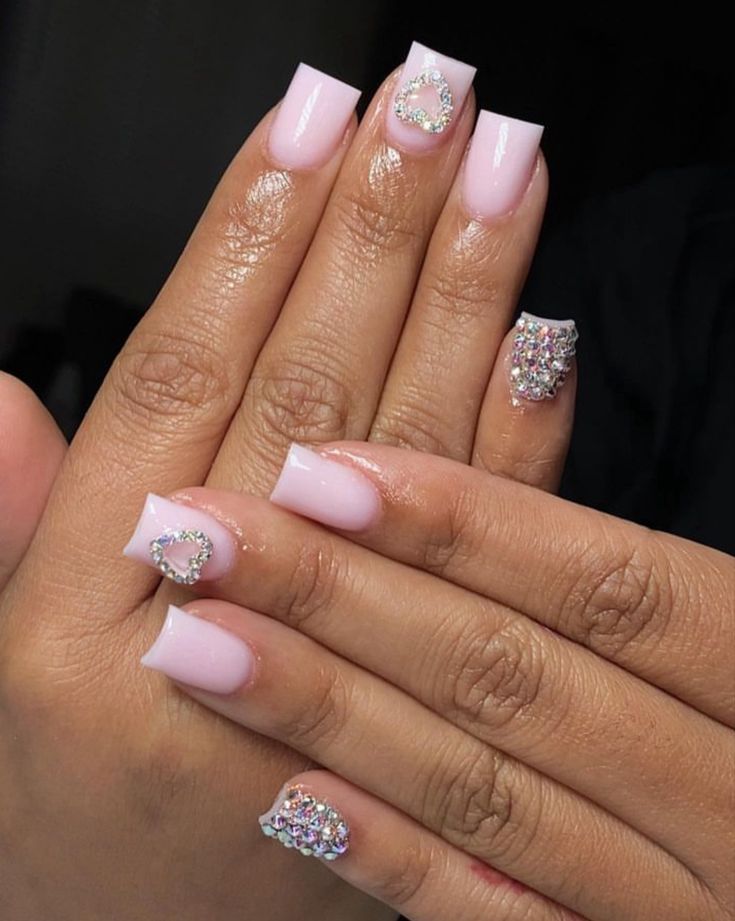 Chic Soft Pink Nail Design with Sparkling Heart Accents and Square Tips.