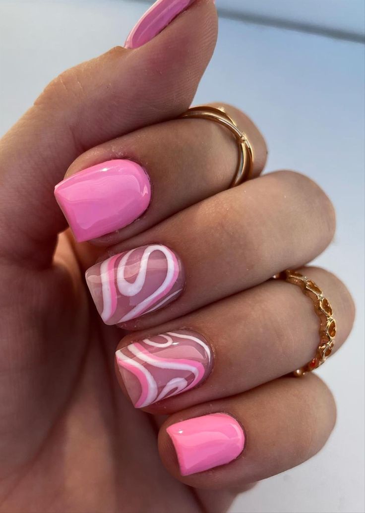 Vibrant Pink Nail Design with Elegant White Swirls for a Playful Touch.