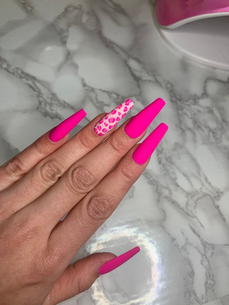 Bold pink stiletto nails with leopard print accent and mixed finishes for a playful statement look.