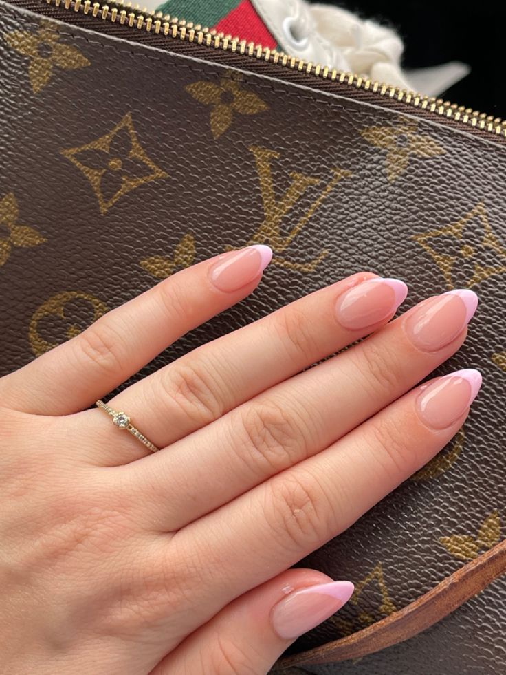 Sophisticated Almond-Shaped Nails with Soft Pink Base and Delicate French Tips.