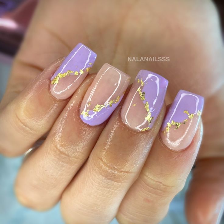 Chic Nail Design: Elegant Soft Purple with Gold Foil Accents and Geometric Glossy Finish.