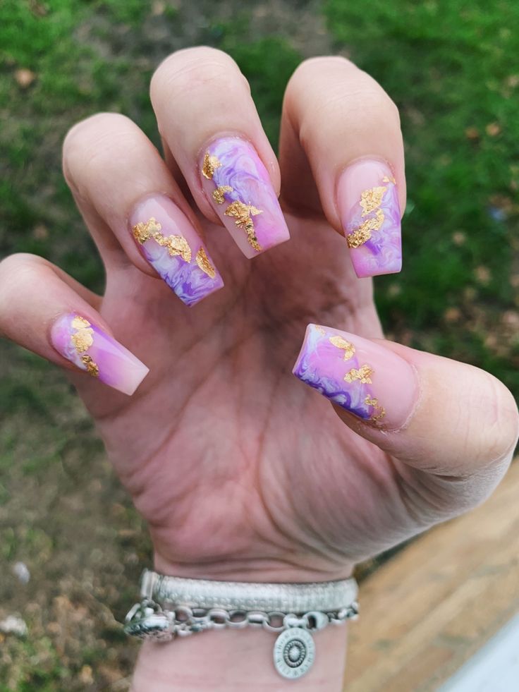 Elegant Dreamy Purple and Gold Marbled Nail Art for Trendy Long Nails.