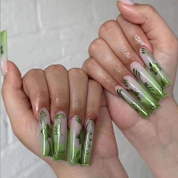 Elegant Elongated Nail Design with Intricate Green Floral Patterns for a Fresh, Unique Look.