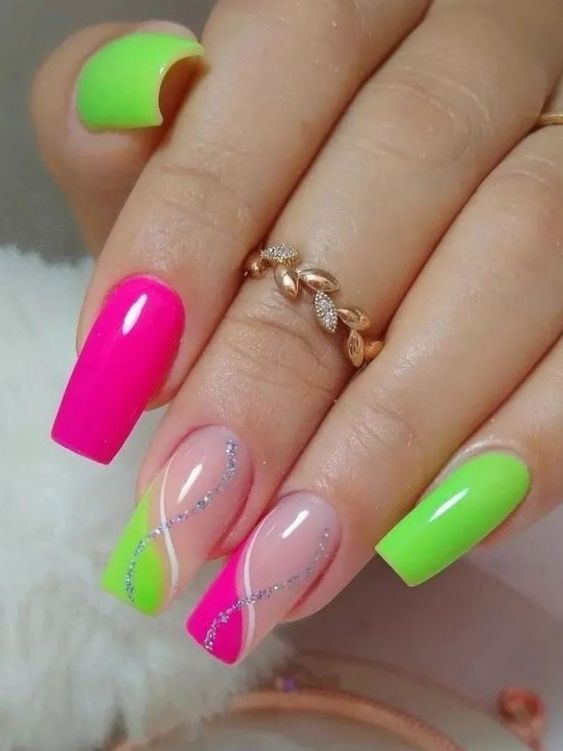 Vibrant Bold Neon Nail Design: Pink and Green Swirls with Glitter Accents for a Playful Glamorous Look.