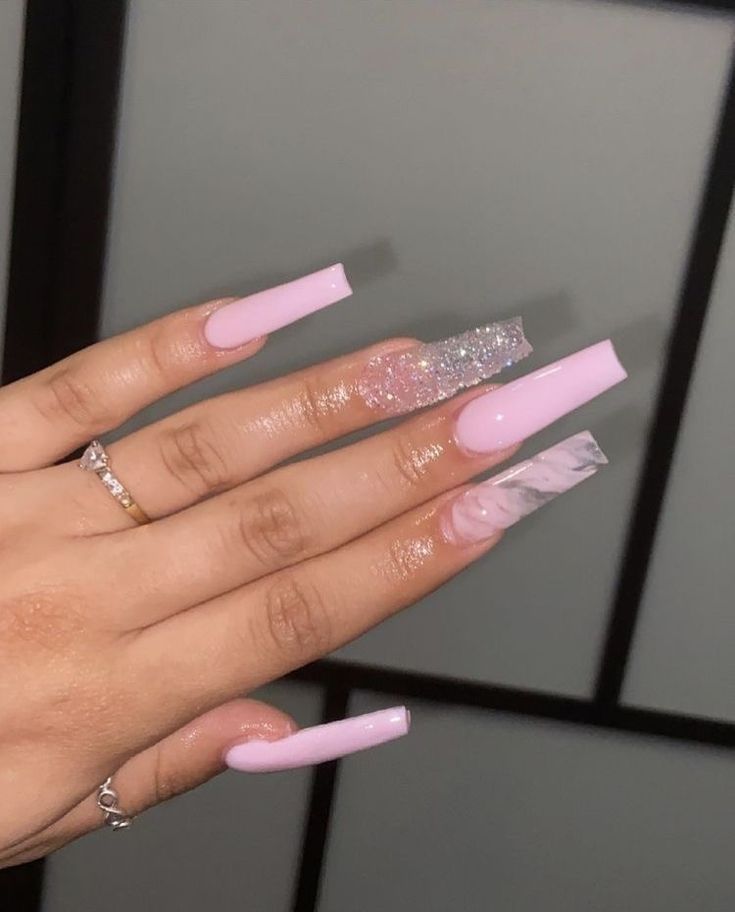 Glamorous Long Pink Acrylic Nails with Textured Embellishments and Marbled Accents.