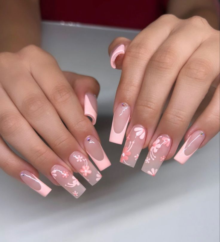 Sophisticated Soft Pink Nail Design with Floral Patterns and French Tips.