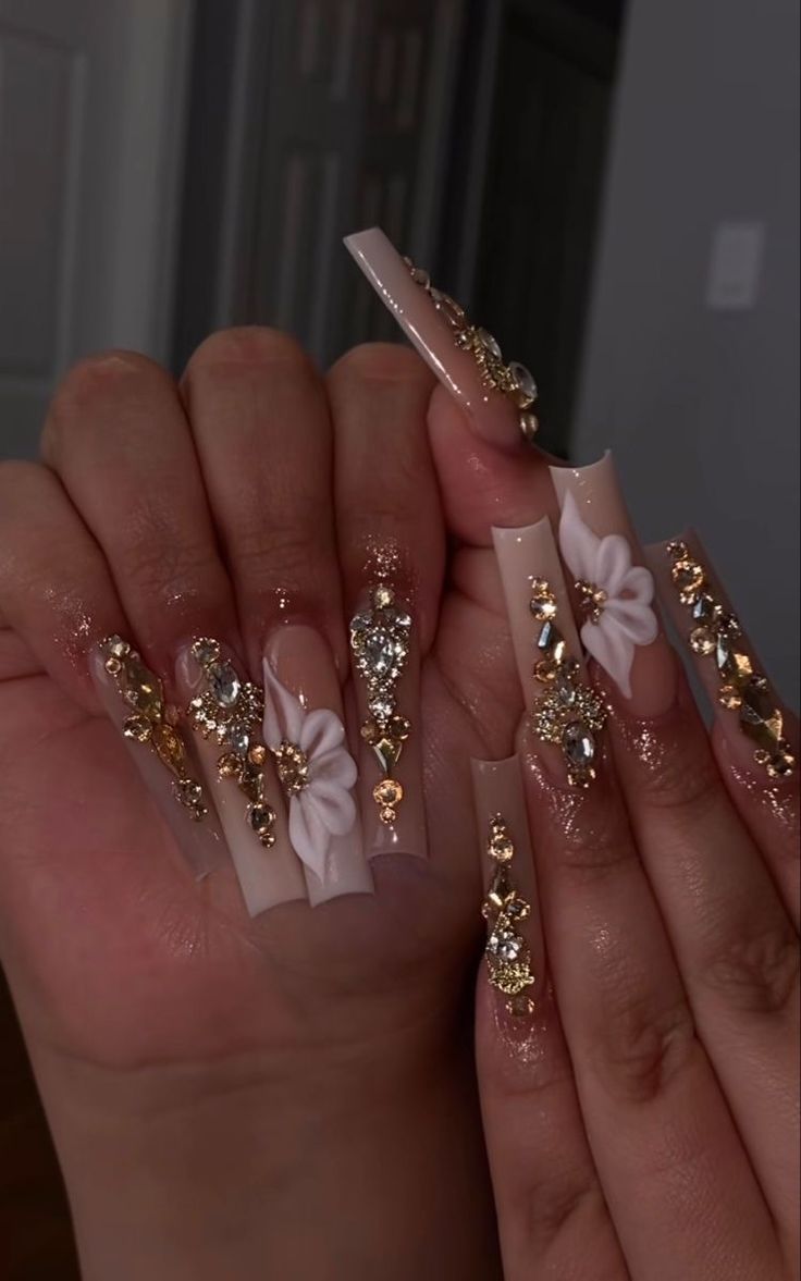 Chic Nail Art: Long Nude Acrylics with Glamorous Gold and Rhinestone Accents