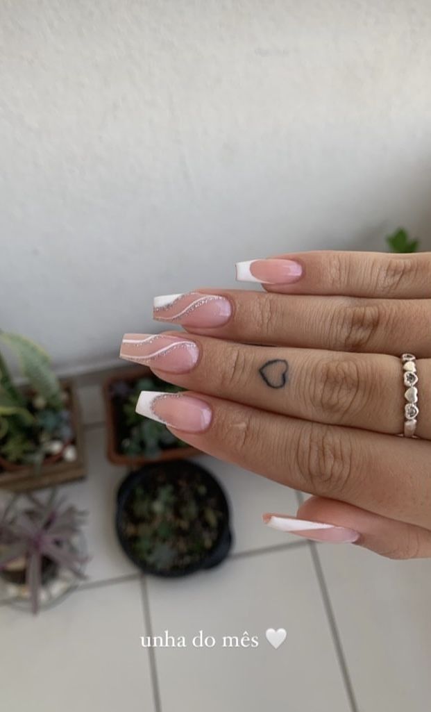 Chic Elegant Nail Design with French Tips, Soft Pink Tones, and Heart Tattoo.