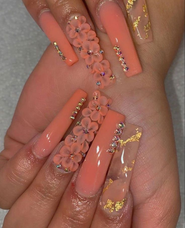 Elegant Vibrant Coral Nail Design with 3D Floral Accents and Gold Flakes for Special Occasions