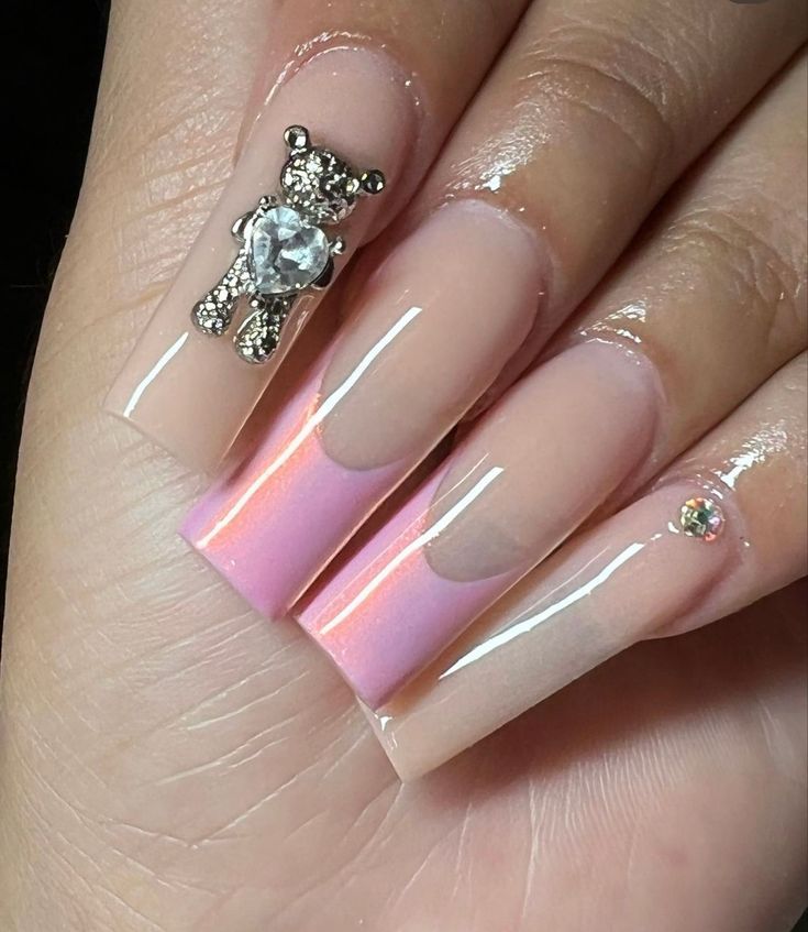 Chic Long Glossy Gradient Pink and Nude Nail Design with Playful Teddy Bear Charm.