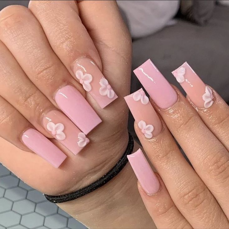 Elegant Chic Pink Nail Design with Glossy Finish and Floral Accents.