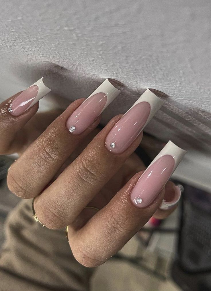 Chic French Manicure: Soft Pink Base with Glamorous White Tips and Rhinestone Accents.