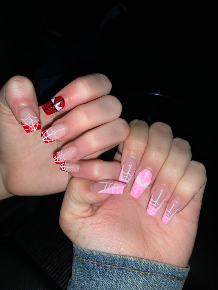 Whimsical Halloween-Inspired Nail Design with Intricate Spider Web Patterns in Red and Pink.